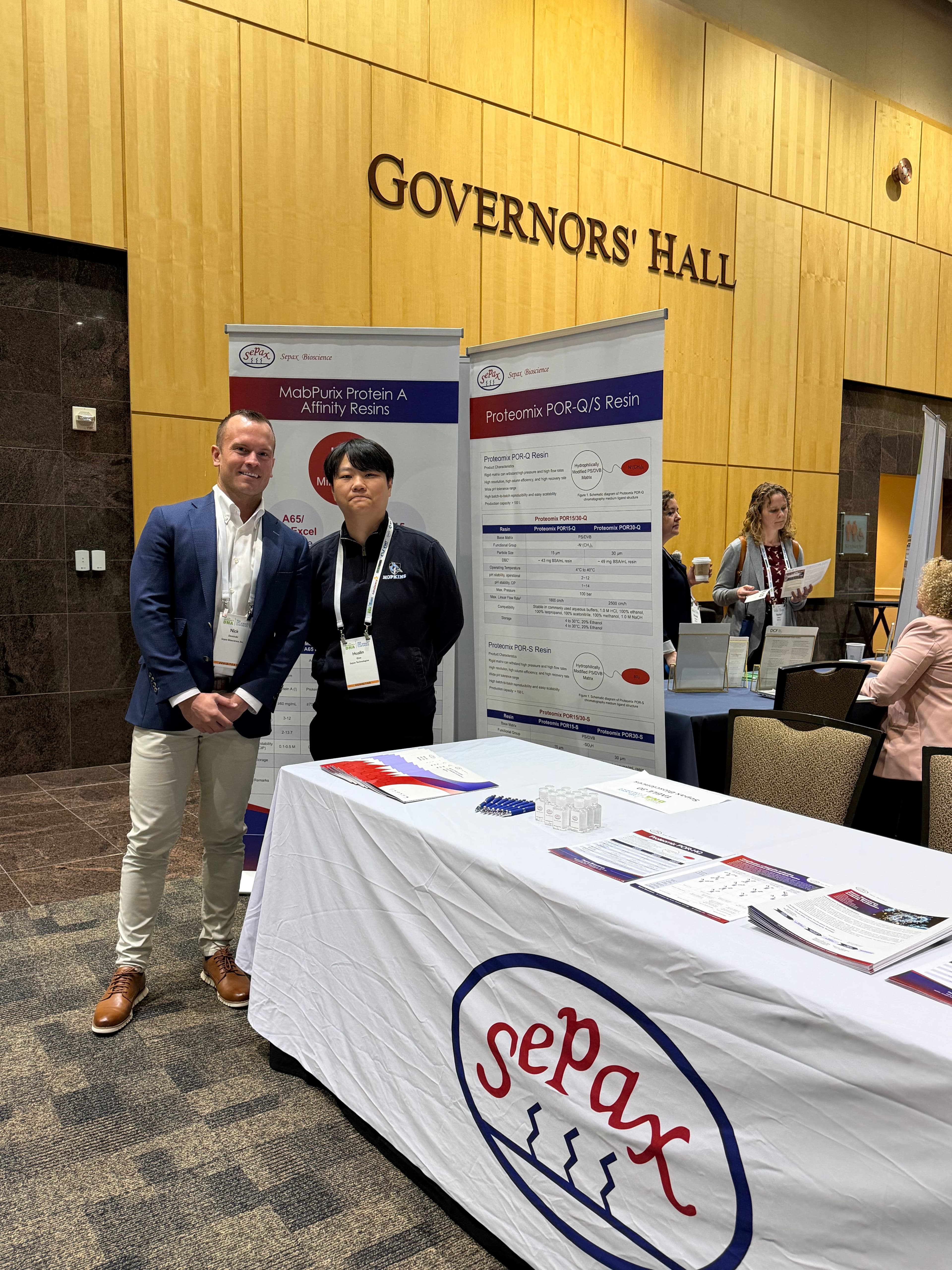 Sepax Bioscience team at Governors' Hall trade show booth with MabPurix and Proteomix product displays